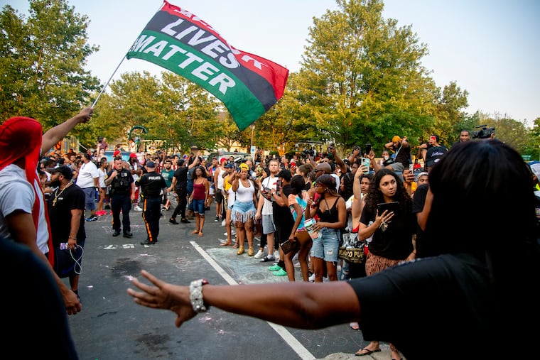 Protesters clear a path so police can bring out Edward Cagney Mathews through the crowd that gathered outside his Mount Laurel home July 5, 2021. The crowd converged after a video went viral said to show Mathews shouting racial slurs and offensive language at his neighbors.