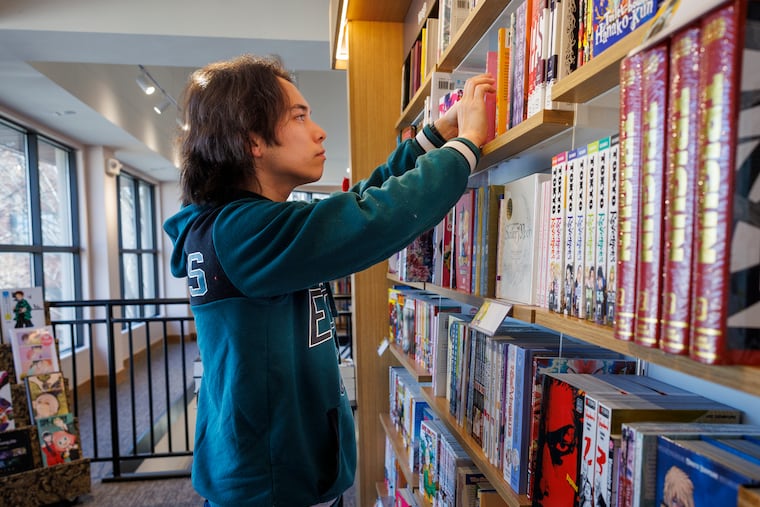 Stephen Smeds arranges books on shelves at the soon to open Barnes and Noble in Bryn Mawr. This spring, several Philly authors are releasing their works. Photograph taken on Monday, Feb. 10, 2025.