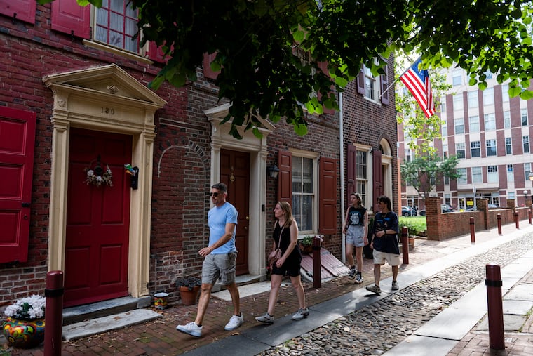 A family walks down Elfreth’s Alley on Monday, July 3, 2023. On Monday, Elfreth’s Alley Museum houses were open and pay-what-you-wish as part of Wawa Welcome America.
