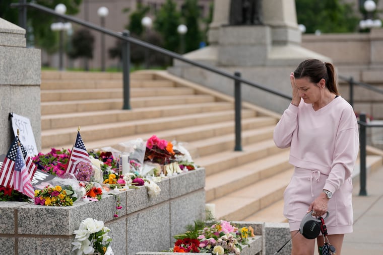 Leah Palmer visits a makeshift memorial for Minnesota state Rep. Melissa Hortman and her husband Mark at the state Capitol, Sunday, in St. Paul, Minn.