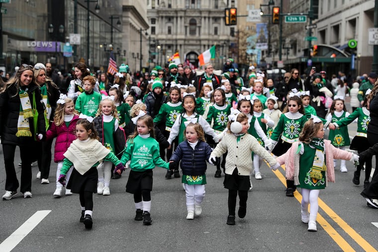 Dancers from the McDade-Cara School of Irish Dance travel down Market Street during the St. Patrick’s Day Parade in Philadelphia on March 12, 2023.