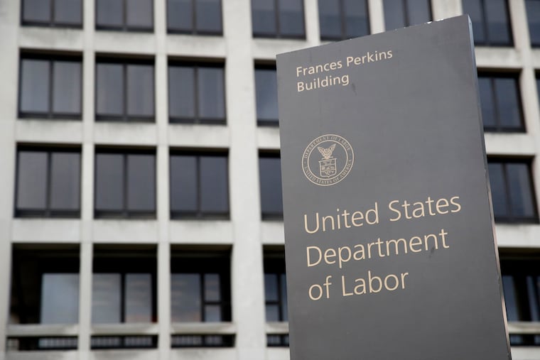 A sign stands outside the U.S. Department of Labor's headquarters, May 6, 2020, in Washington.
