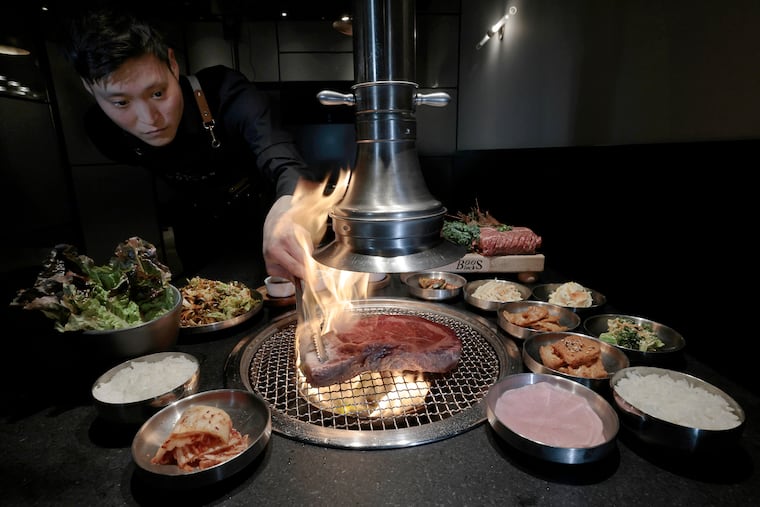 BBQ captain Jason Kim cooks the prime rib eye part of the “Korean BBQ Combo B” (prime cha dol begi, prime rib eye, marinated prime kalbi, steamed egg, scallion salad, doenjang jigae or kimchi jigae) at Dolsan Korean BBQ in Mount Laurel.