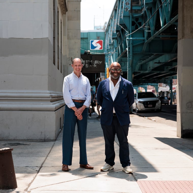 Tayyib Smith and Jacob Roller outside of the historic bank they plan to turn into a base for Black-owned businesses and market rate apartments, near the Huntingdon El station in Philadelphia.