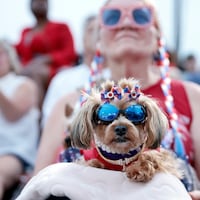 Lori Ney of Wynnewood and her dogs Ava (in front) and Lilly (behind Ava) attend the patriotic, all-star concert by the US Army’s Pershing’s Own followed by fireworks at the Great Plaza at Delaware River Waterfront in Phila., Pa. on Sat. July 01, 2023.