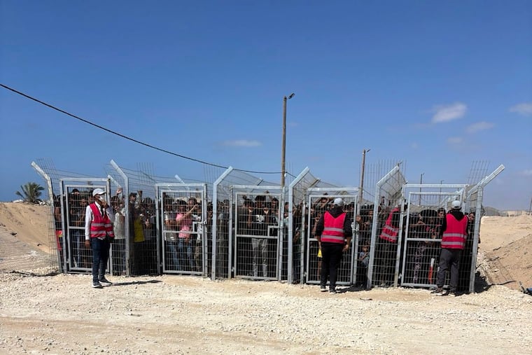 This photo, provided by an American contractor on condition of anonymity, shows Palestinians behind gates before entering a food distribution site operated by the Gaza Humanitarian Foundation in May 2025, shortly after the start of the organization's distribution sites.