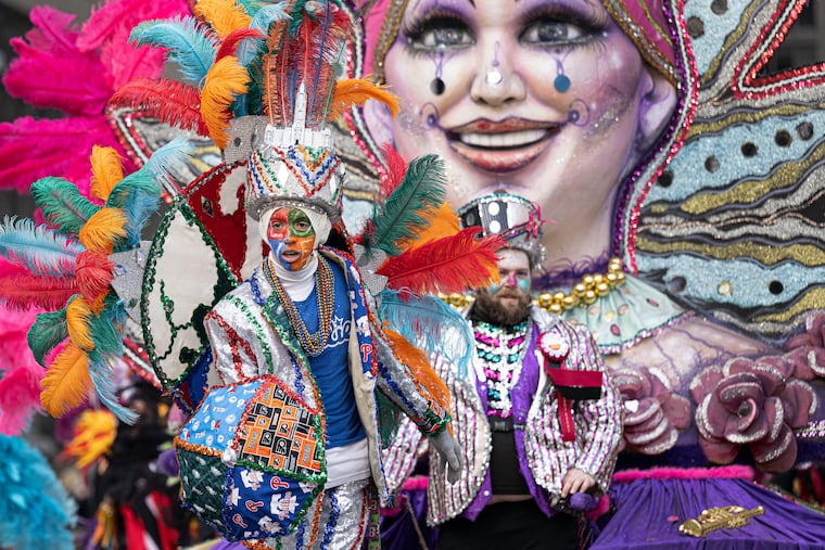 Golden Sunrise Fancy division's Aidan Anderson struts down Market Street during the start of the Jan 1, 2024, Philadelphia Mummers Parade.