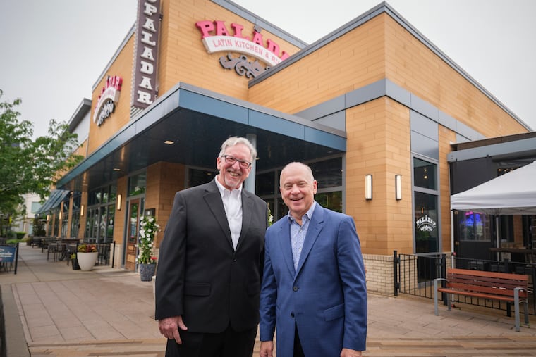 Larry Cohen (left) and Barry Gutin, partners with GuestCounts Hospitality, outside Paladar Latin Kitchen in King of Prussia. It's one of their new suburban acquisitions, along with Bomba locations in Malvern and Newtown.