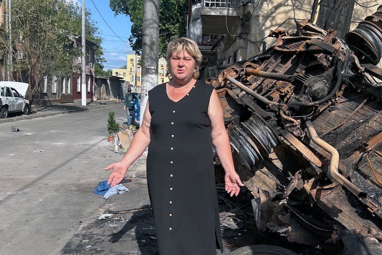 Natalya Dubchek stands next to a minibus destroyed by a Shahed drone. The fire from the explosion torched her home in Odesa, Ukraine.