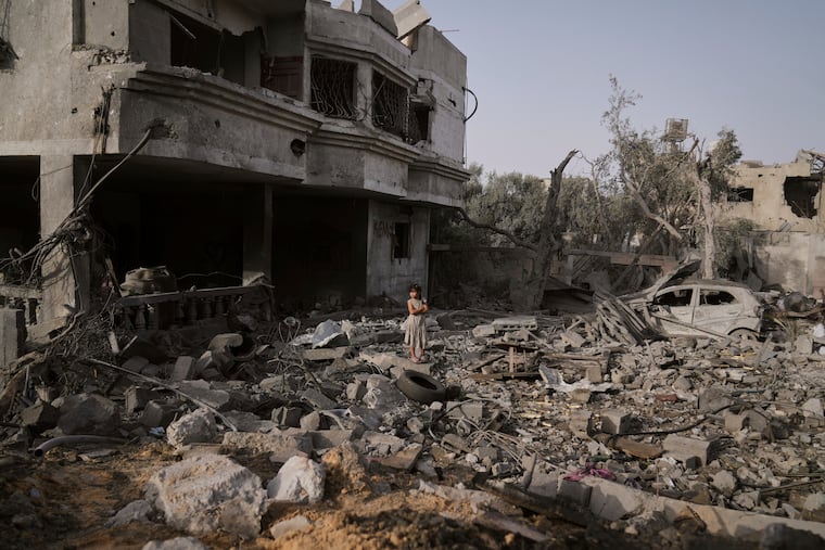 A Palestinian girl stands atop the rubble of the Al-Aimawi family’s home that was destroyed by Israeli airstrikes in Al-Zawaideh, Gaza Strip, on Tuesday, July 1, 2025.