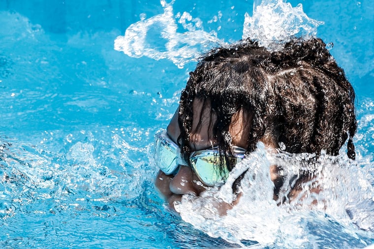 Makhi Miller, 11, enjoys the water spout on a 90-degree day on the first day the pools opened at the Chew Pool in June.