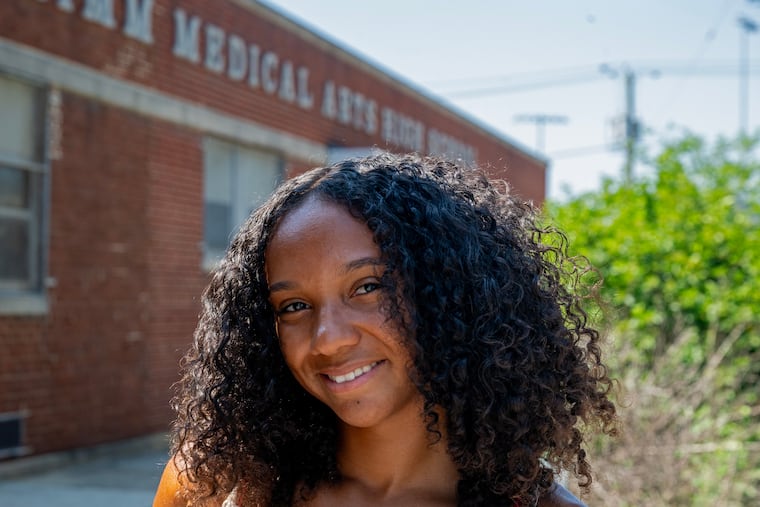 Jordan Hawkins poses outside her former, now-closed school, the Dr. Charles E. Brimm Medical Arts High School, Wednesday, Jun. 25, 2025. She spent her senior year  learning virtually because of the pandemic. She just graduated from the University of Arizona, and plans to pursue a Master's degree
