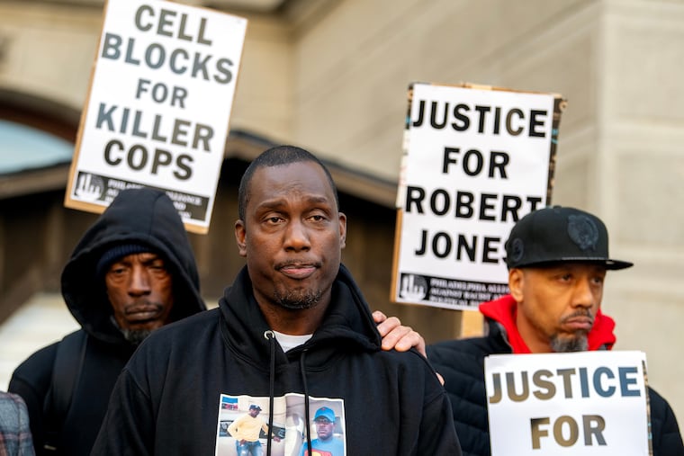 Michael Jones (center), the younger brother of Robert Jones, attends a rally outside City Hall on Nov. 18, 2024. Jones' family said they had received no updates from the city in the six weeks since the unarmed man was shot and killed by an off-duty Philadelphia homicide detective.