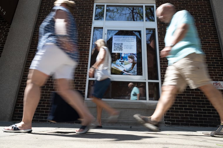 Pedestrians walk by the Library Company of Philadelphia building on Wednesday.