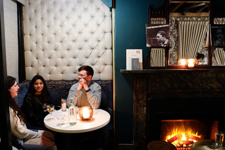 Jenna Shelby-Glick (left), Spoorthi Sampath (center) and Forrest Beaulieu sit in corner table at the 48 Record Bar, a vinyl centric cocktail bar in Old City on Thursday, February 29, 2024.
