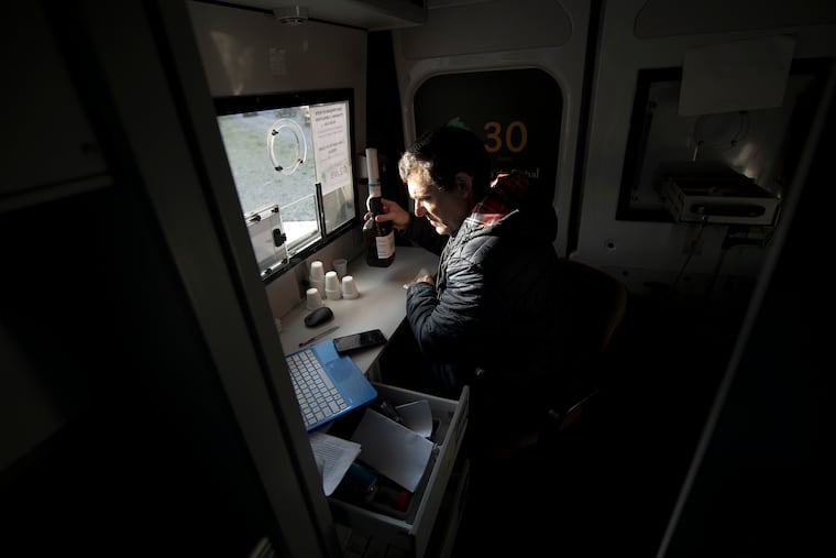 A staffer dispenses methadone from a mobile clinic in Lisbon, Portugal. Philadelphia health officials say they are on track to spend $1.2 million on a similar program before the end of this year.