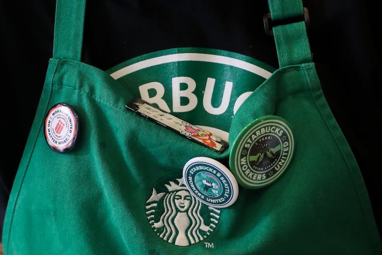 Ella Valdivia wears pins at the Starbucks at 901 Market St. in Philadelphia on Tuesday, Feb. 7, 2023.