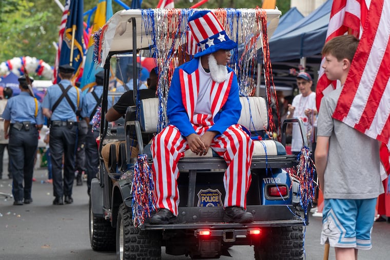 Elijah Thomas,14, with the Philadelphia Police Explorer Cadets rides as Uncle Sam.
