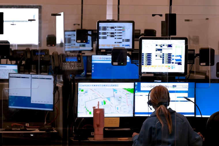 A call center dispatcher works as Councilmember Jamie Gauthier and Police Commissioner Kevin Bethel host a news conference (not shown) in the Radio Room at Police Headquarters on Aug. 22, 2024  to discuss changes to the department’s 911 Call Center. 
