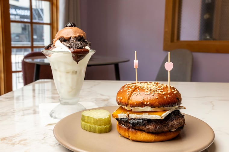The cheeseburger dessert at Roxanne, on South Second Street — a rare burger on a crispy, sesame-seeded house-baked bun, layered with a thick slice of Red Rock blue cheese and raw onions in creamy mayo and served alongside a chocolate sundae. 